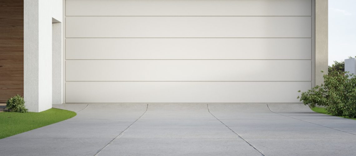 Modern house and big garage with concrete driveway.